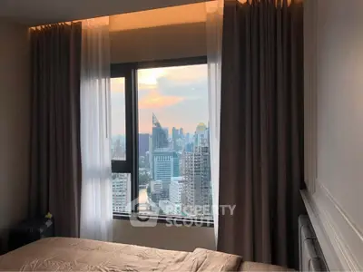 Stunning bedroom view of city skyline with floor-to-ceiling windows and elegant curtains.