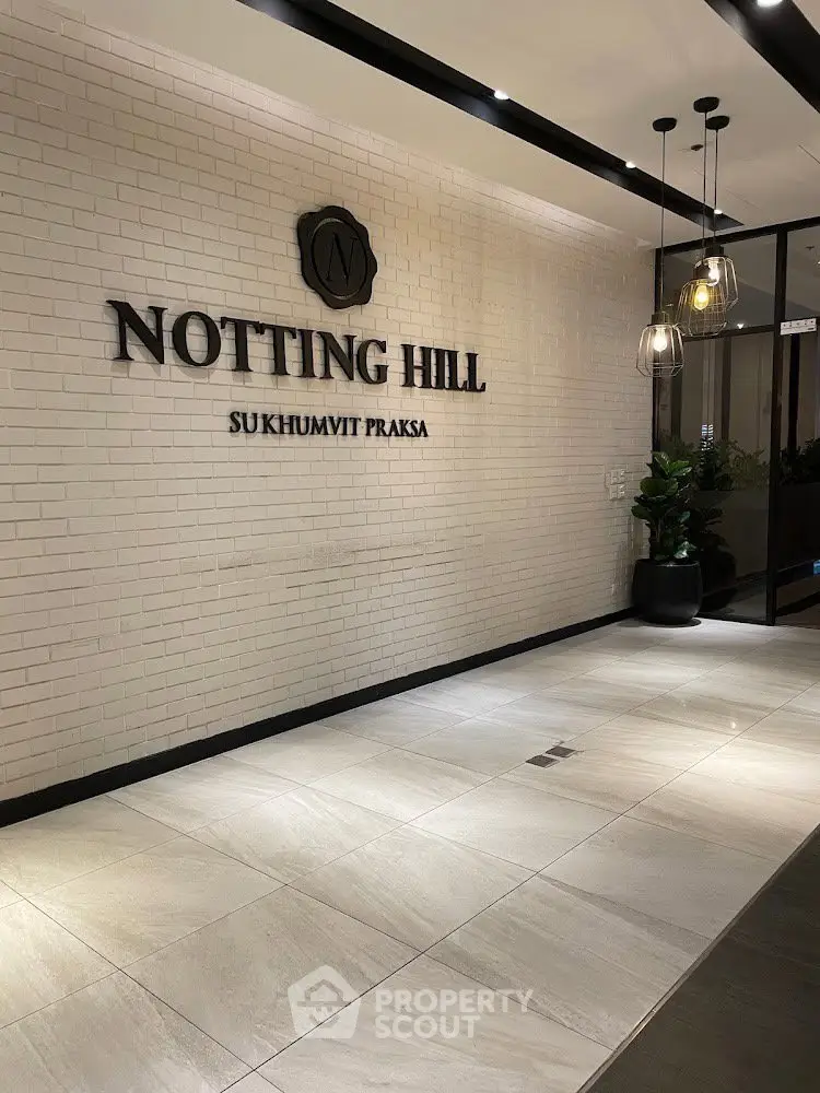 Elegant entrance of Notting Hill Sukhumvit Praksa with modern lighting and stylish decor.