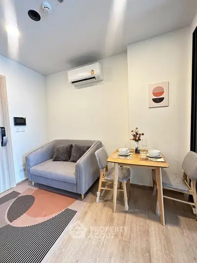 Cozy living room with modern decor and dining area, perfect for urban living.