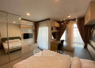 Modern bedroom with stylish decor, large mirror, and ample natural light.