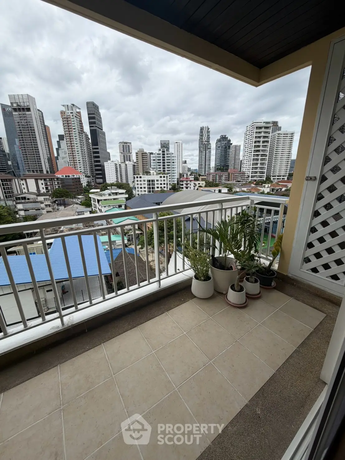 Spacious balcony with city skyline view, perfect for urban living enthusiasts.