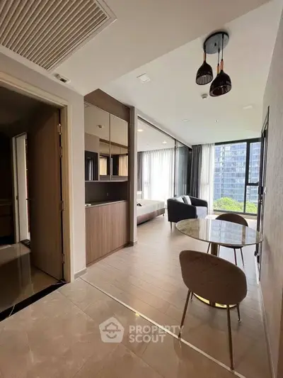 Modern open-plan living area with dining space and large windows offering a city view.