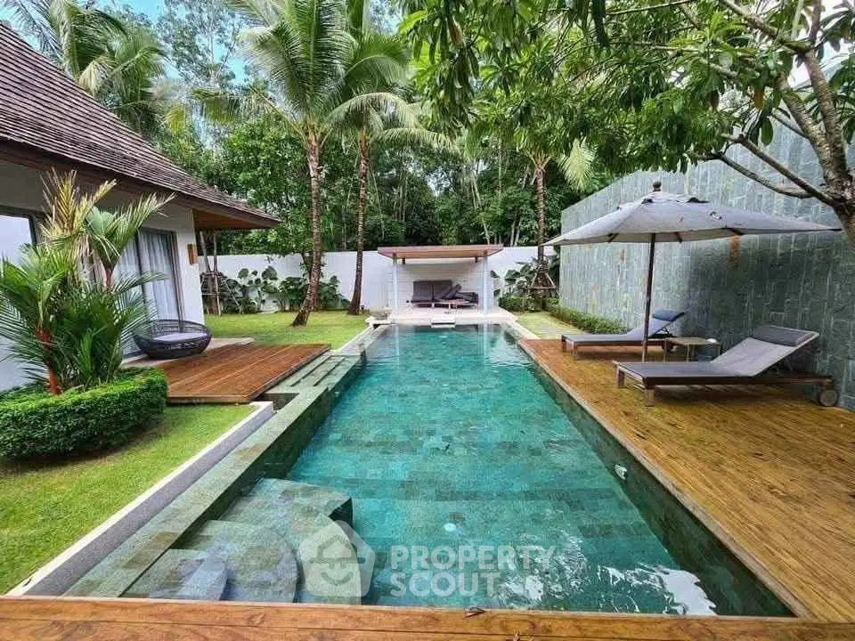 Luxurious tropical villa with private pool and lush garden, perfect for relaxation and entertaining.
