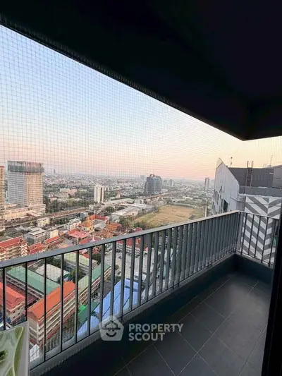 Stunning cityscape view from a high-rise balcony with safety netting, perfect for urban living.