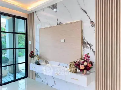 Elegant modern living room with marble accent wall and stylish decor