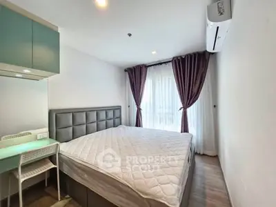 Modern bedroom with large bed, stylish curtains, and air conditioning