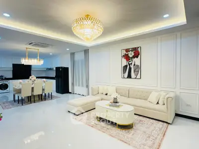 Luxurious open-plan living room with elegant chandelier and modern decor