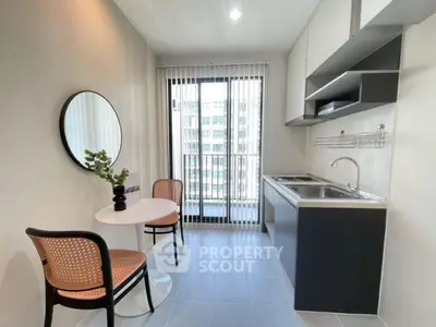 Modern kitchen with sleek design and balcony view in urban apartment