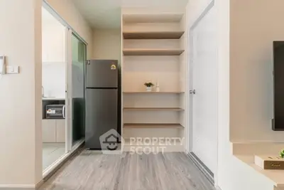 Modern apartment interior with sleek kitchen and spacious shelving