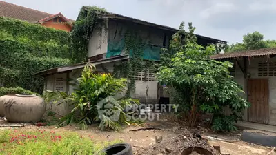Rustic property with lush greenery and potential for renovation