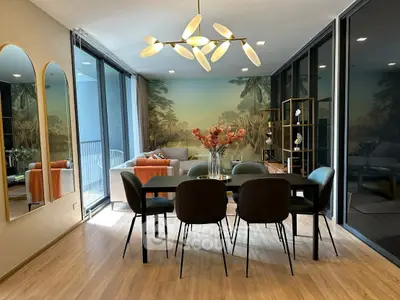 Elegant dining area with modern chandelier and scenic wall mural in luxury apartment