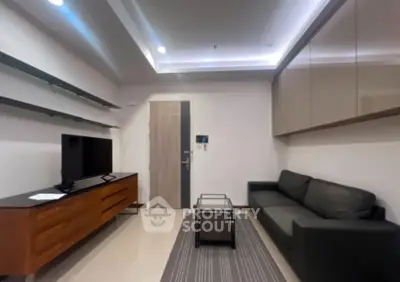 Modern living room with sleek furniture and ambient lighting, perfect for relaxation and entertainment.