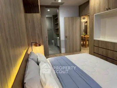 Modern bedroom with wooden accents and ensuite bathroom in luxury apartment
