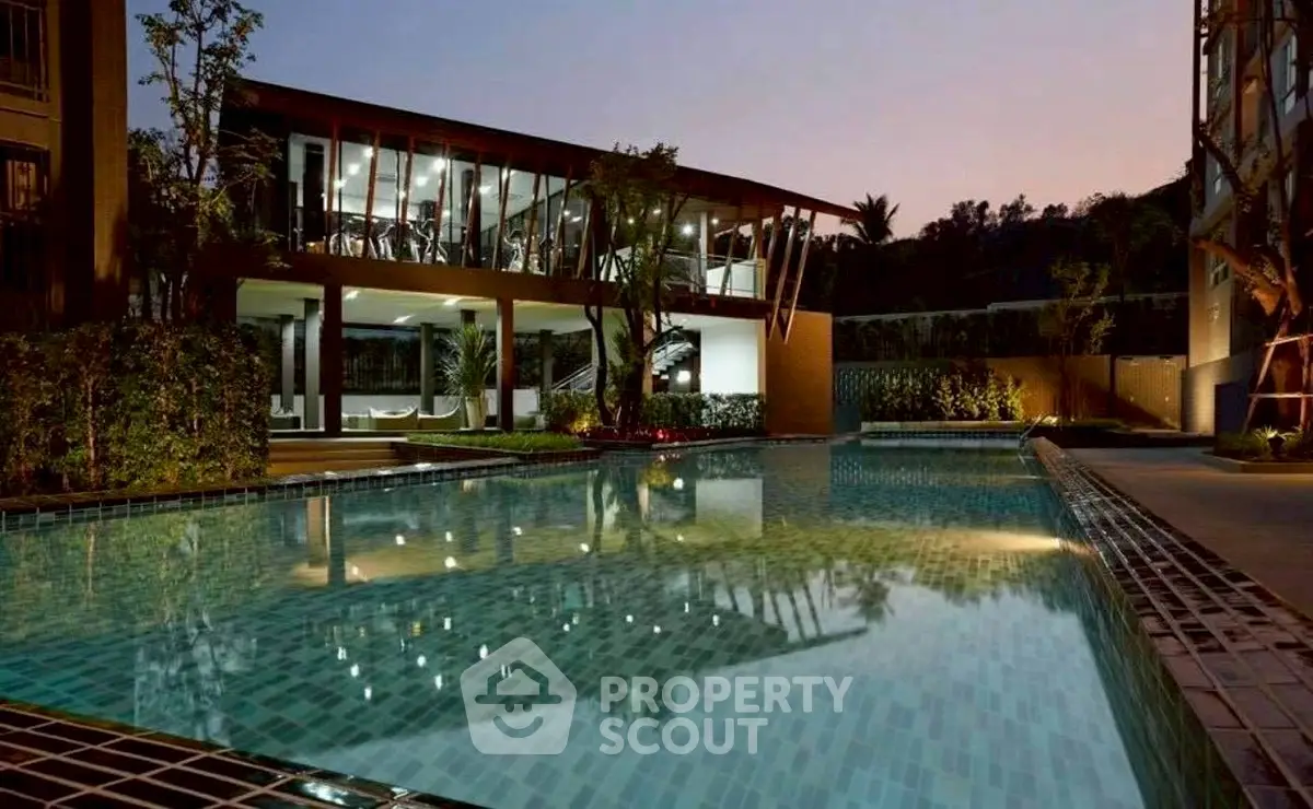 Luxurious poolside view at dusk with modern building and lush greenery, perfect for relaxation and leisure.