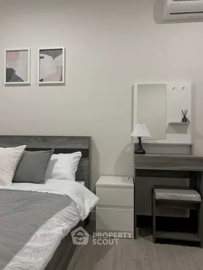 Modern bedroom with stylish decor and cozy ambiance, featuring a sleek bed and elegant furniture.