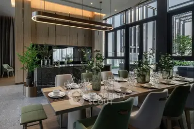 Luxurious dining area with elegant table setting and modern kitchen backdrop.