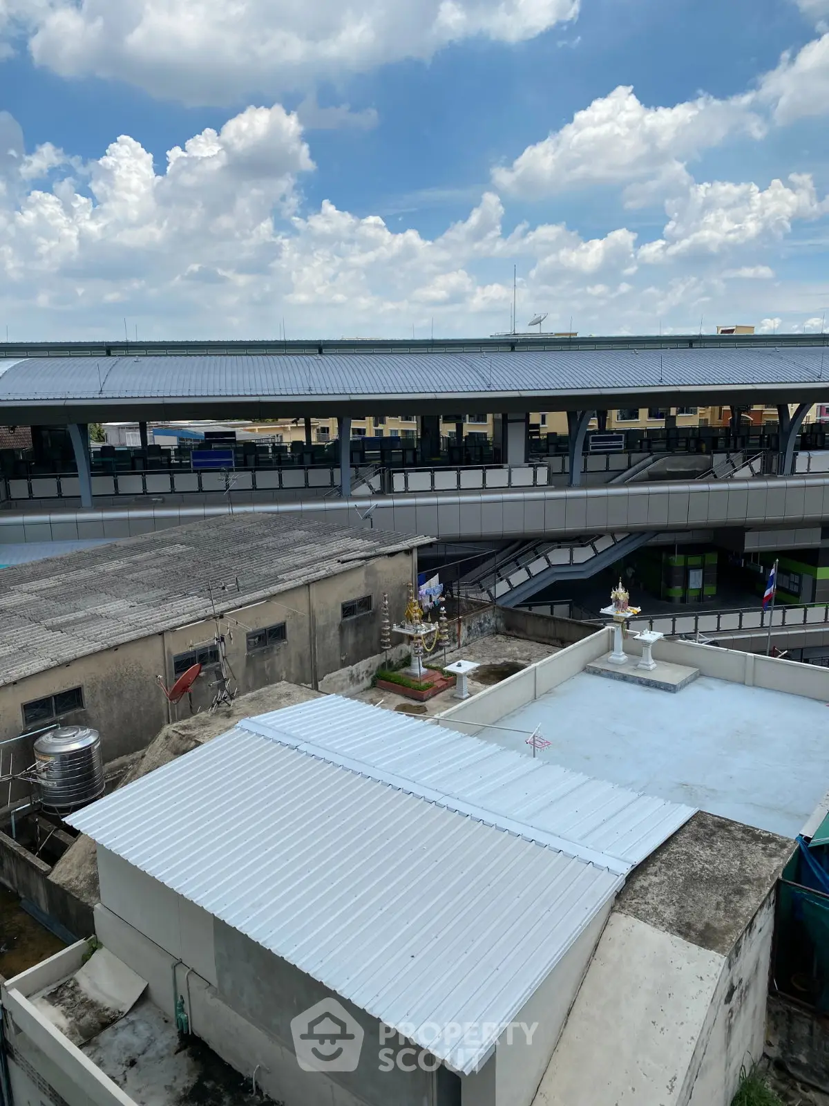 Urban rooftop view with modern transit station and clear blue sky