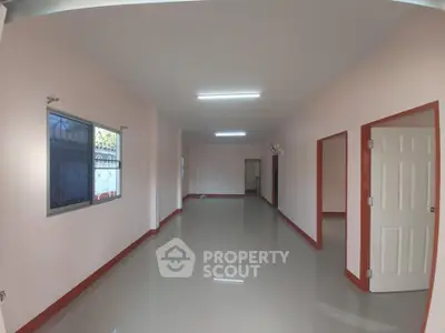 Spacious interior with glossy floors and bright lighting, ideal for versatile living arrangements.
