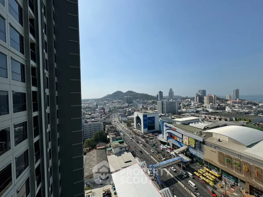 Stunning cityscape view from high-rise building with clear skies and urban landscape.