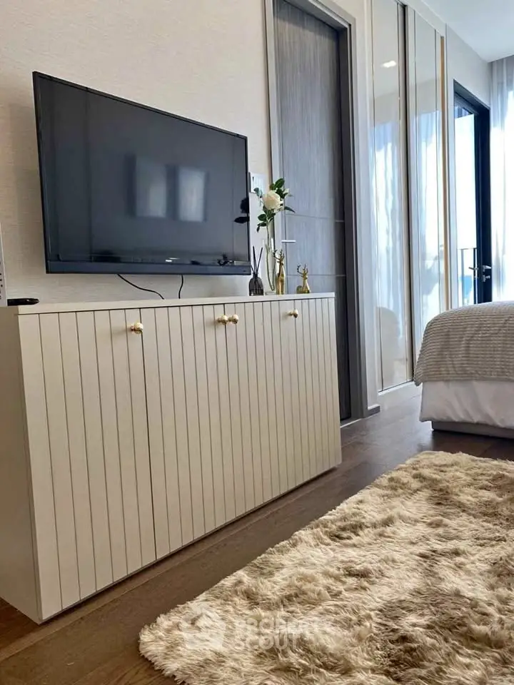 Modern bedroom with stylish TV cabinet and cozy decor