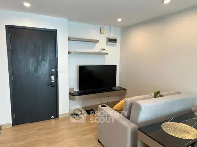Modern living room with sleek TV setup and cozy seating area, perfect for relaxation.