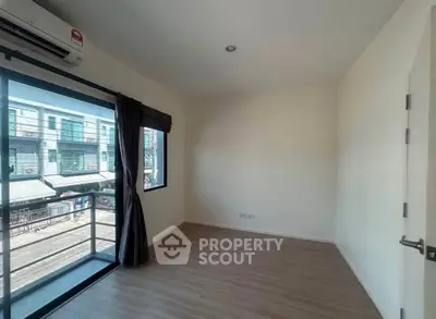 Bright bedroom with large window and balcony access in modern home