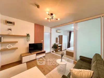 Modern living room with stylish decor and sliding doors to bedroom