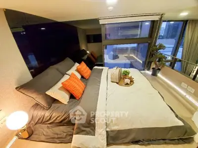 Luxurious modern bedroom with stylish decor and large window view.