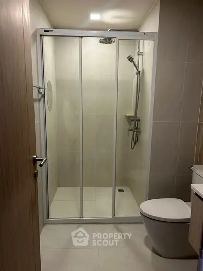 Modern bathroom with sleek shower enclosure and contemporary fixtures.