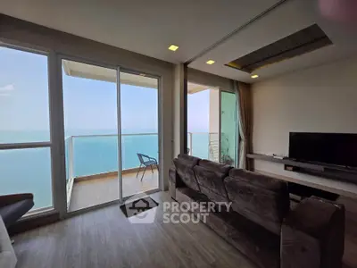 Stunning living room with ocean view and spacious balcony in modern apartment