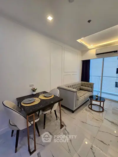 Modern living room with elegant dining area and cozy sofa in a stylish apartment.