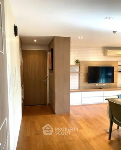 Modern living room with wooden flooring and stylish TV unit