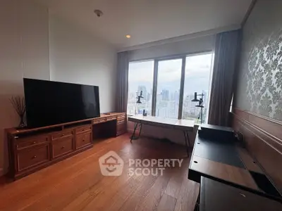Spacious living room with city view, wooden flooring, and modern entertainment setup.