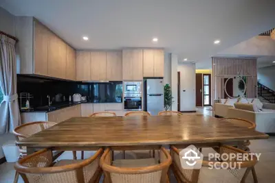 Spacious open-plan kitchen and dining area with modern wooden furniture