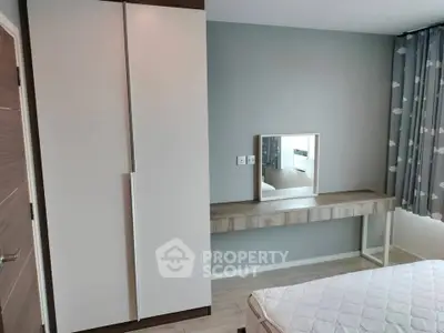 Modern bedroom with sleek wardrobe and stylish dressing table, perfect for contemporary living.