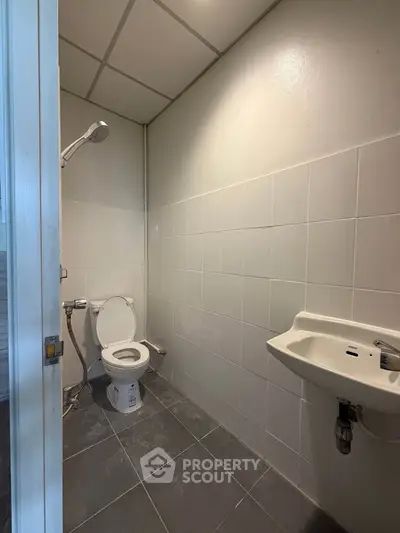 Compact bathroom with shower and toilet in modern apartment