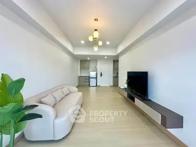 Modern living room with sleek furniture and open kitchen layout