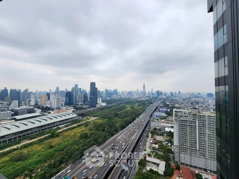 Stunning cityscape view from high-rise building overlooking highway and skyline.