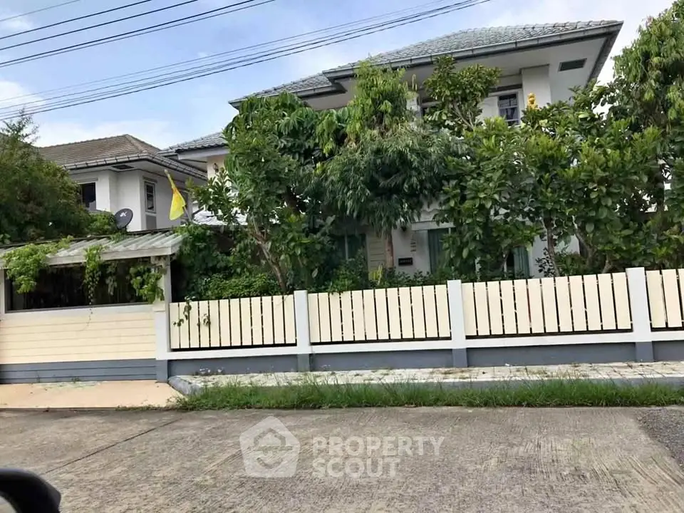 Charming suburban house with lush greenery and modern design, perfect for family living.