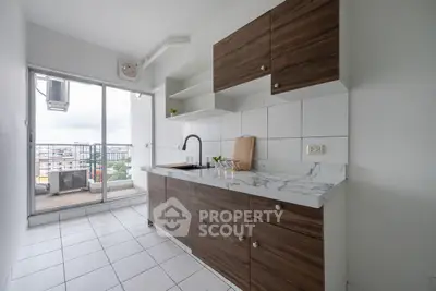 Modern kitchen with marble countertop and balcony view in urban apartment