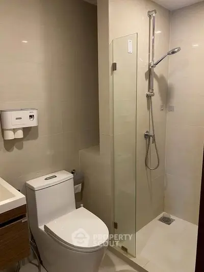 Modern bathroom with sleek shower and contemporary fixtures.