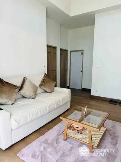 Modern living room with cozy sofa and stylish coffee table in bright apartment