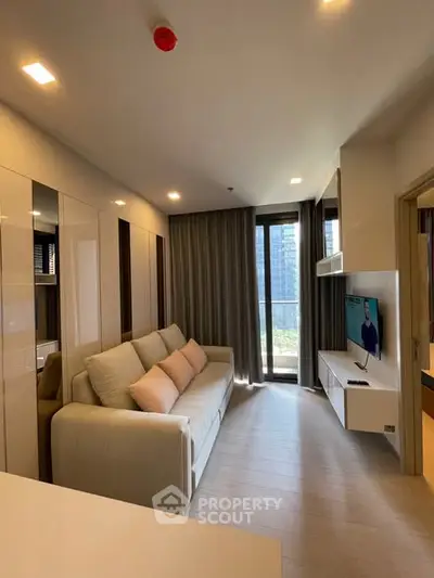 Modern living room with sleek design and large windows offering a city view, perfect for urban living.