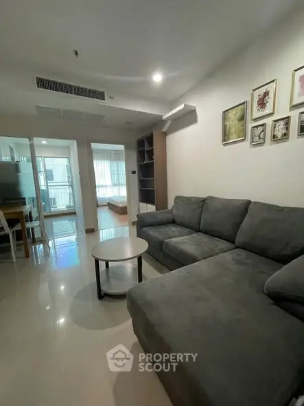 Spacious living room with modern sofa and stylish decor in a contemporary apartment.