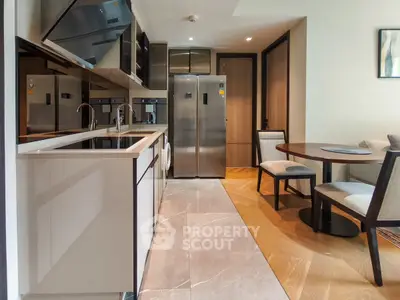 Modern kitchen with sleek appliances and dining area in stylish apartment