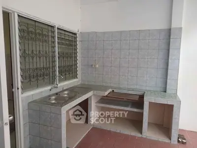 Spacious tiled kitchen with open layout and modern sink