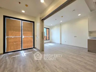 Spacious modern living room with large windows and elegant flooring