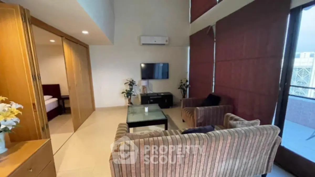Spacious living room with modern furniture and large windows for natural light.