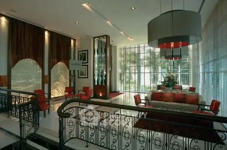 Luxurious lobby with elegant decor and large windows offering garden views.