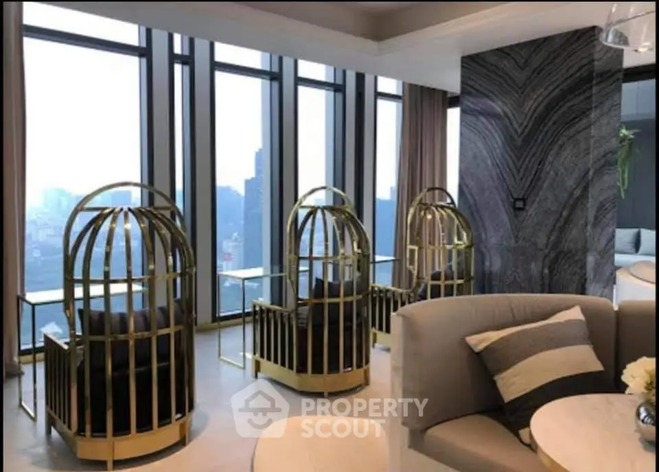 Luxurious modern living room with unique cage-style chairs and panoramic city views.